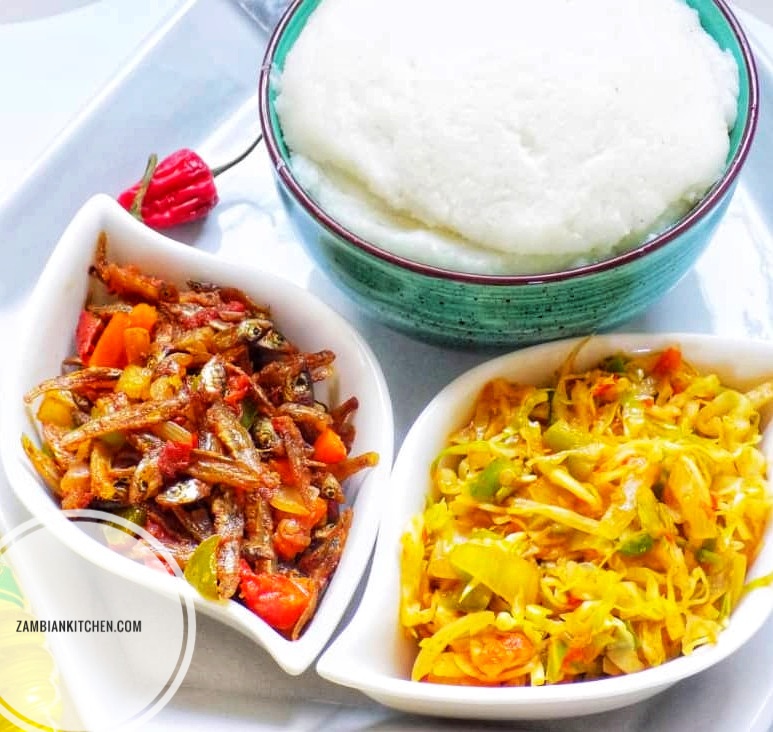 popular foods in Zambia, nshima with Kapenta and cabbage